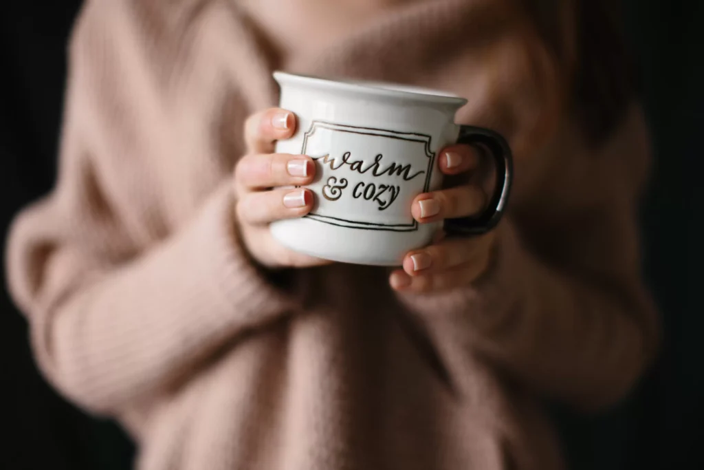 woman holding warm mug