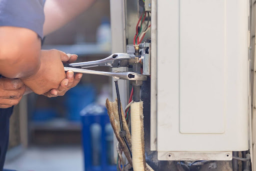 technician fixing an HVAC unit