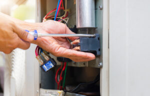 Close up of Air Conditioning Repair, repairman installing magnet