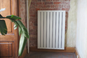 White radiator on grey white wall