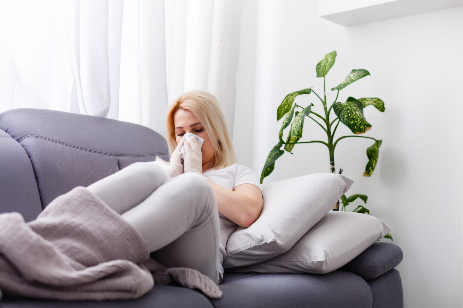 sick woman sneezing